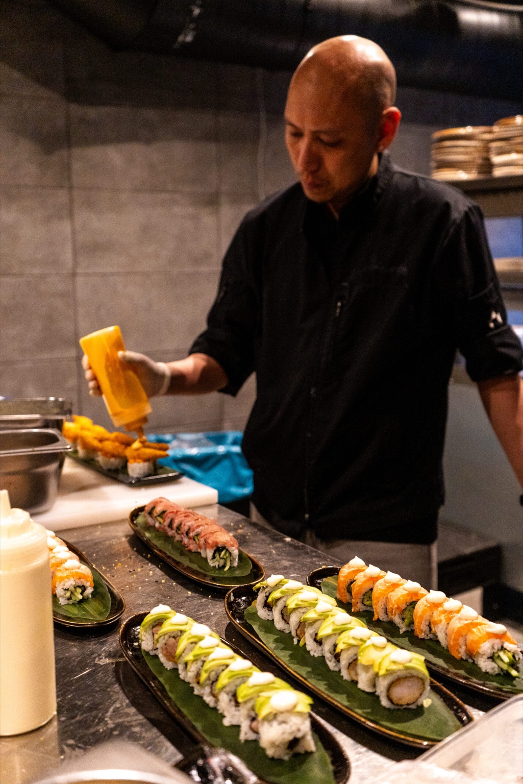 Sushi chef plating signature rolls at Donzo halal Japanese restaurant
