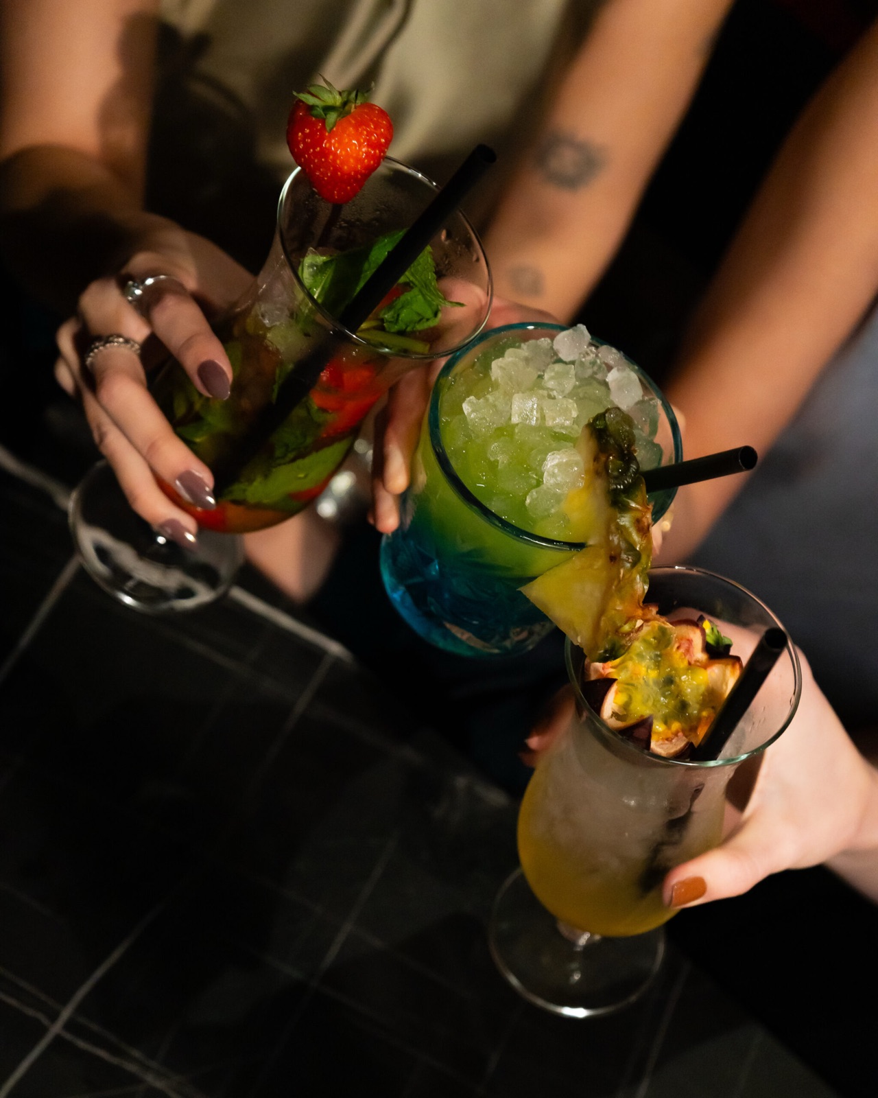 Three colorful cocktails from above at Donzo Cocktailbar Rotterdam